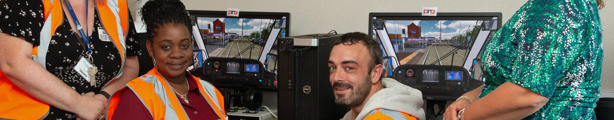 Three women and one man sat at computer simulation