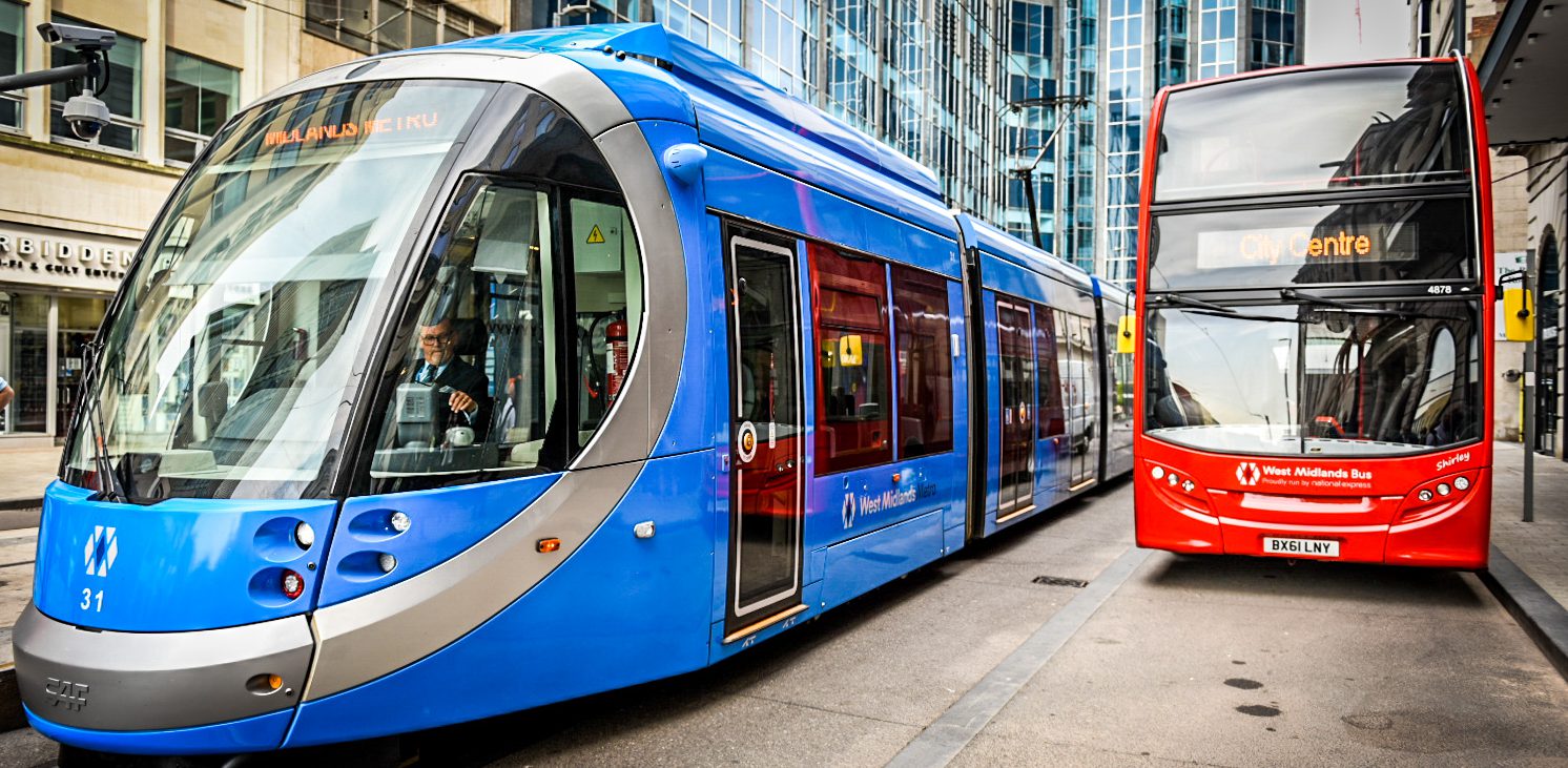 Tram and double decker bus next to one another