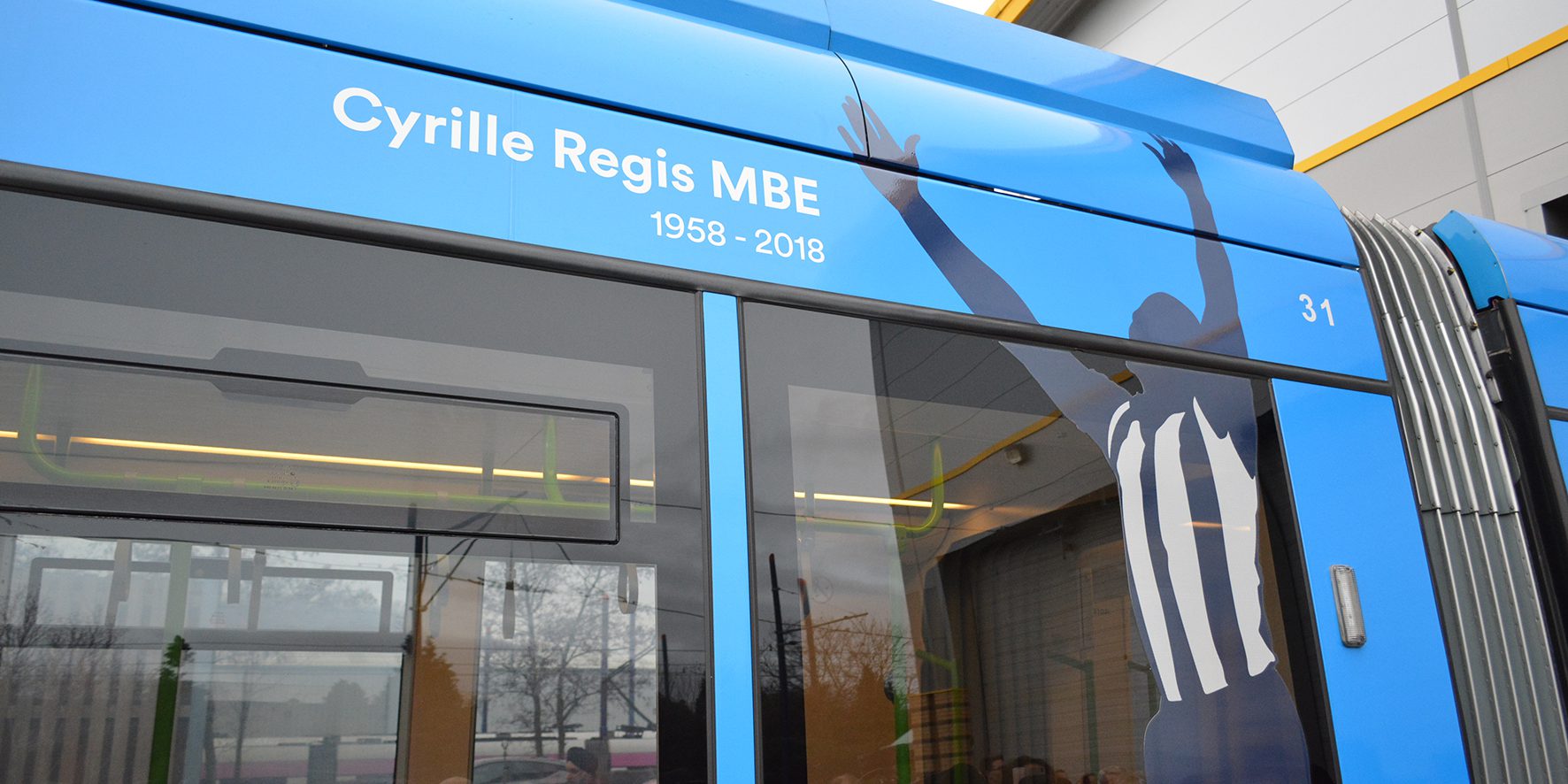 Close up of tram named after Cyrille Regis MBE