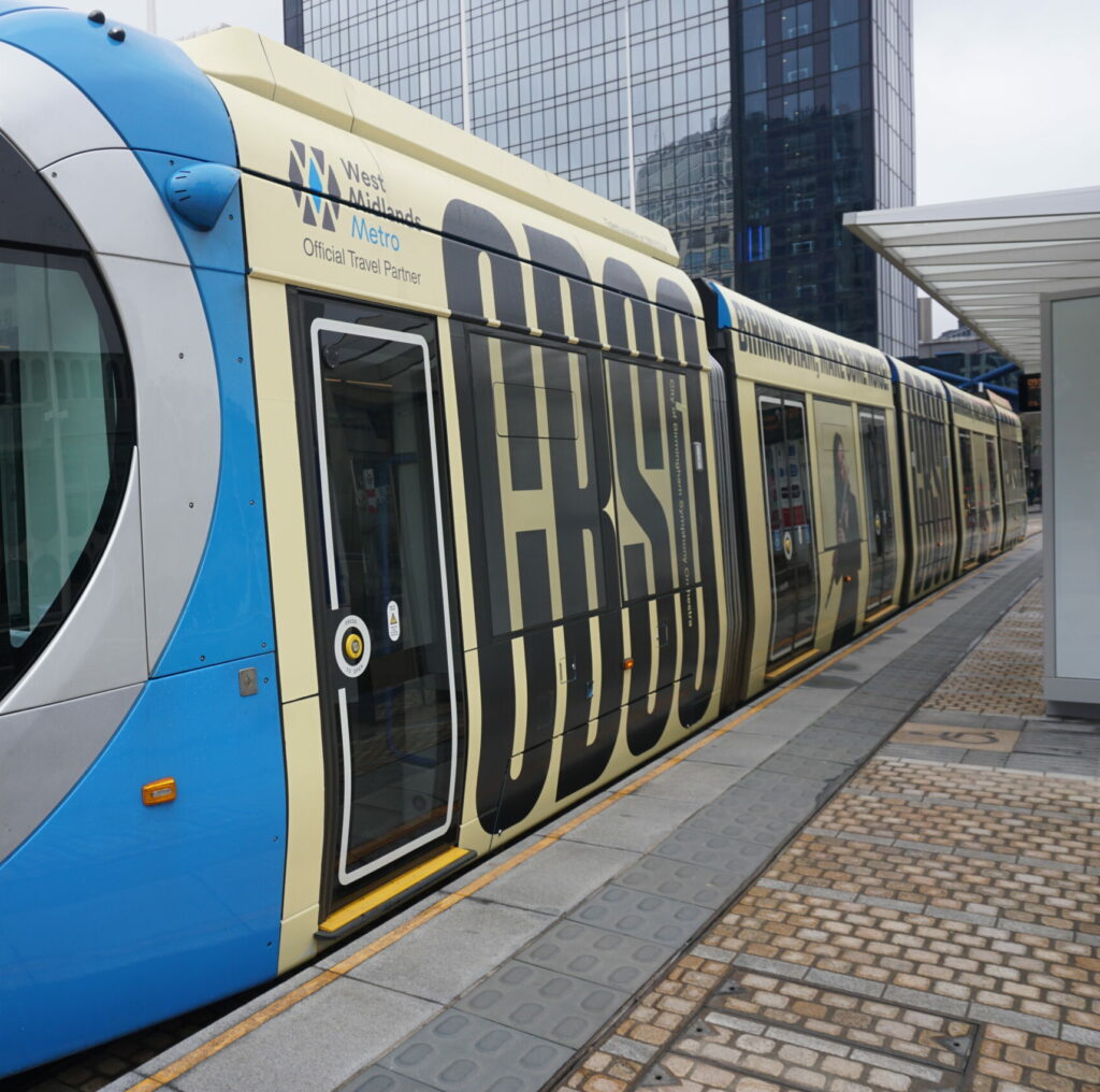 A picture of a tram at it's stop