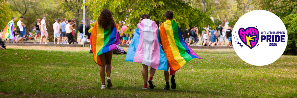 People with pride flags walking into park. Wolverhampton Pride 2026.